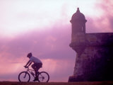 Cycling at El Morro in Old San Juan at Sunset, Puerto Rico Photographic Print by Greg Johnston