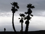 A Man Looks out Towards the Ocean as a Winter Rain Storm Falls on Seal Beach Photographic Print