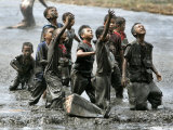 Refugee Children Try to Catch Relief Goods Tossed from an Australian Military Helicopter Photographic Print