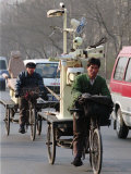 Two Delivery Riders Carry a Dentists Drill and Chair Along a Beijing Street January 4 Photographie