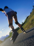 Woman Roller-Blading Along Mountain Road, Canada Photographic Print by Philip Smith