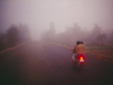 A Couple on a Motorcycle Head into Town Early in the Morning Photographic Print by Justin Guariglia