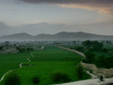 An Afghan Man Rides His Bicycle on a Dirt Road on the Northern Edge of Kabul, Afghanistan Photographic Print by David Guttenfelder
