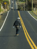 Man Longboarding Down Road, Dunedin, New Zealand Photographic Print by Christian Aslund