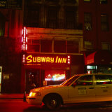 Taxi Passing a Neon Lit Bar, New York City, United States of America Lámina fotográfica por Corey Wise