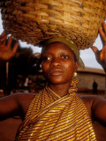 Woman Wearing Gold Fabric Dress and Carrying Basket, Kabile, Brong-Ahafo Region, Ghana Photographic Print by Alison Jones