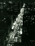 View of New York Illuminated at Night, Traffic Stretches for Miles as Cars Pour into the City Photographic Print