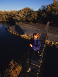 Woman Running Across Foot Bridge, Bluff, Utah Photographic Print by Bill Hatcher