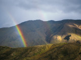 A Rainbow Appears to Touch the Ground in This Landscape View Photographic Print