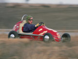 A Young Girl Reacts as She Drives Her "Midget Racer" off the Track Photographic Print by Joel Sartore