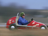 A Young Boy Races a "Midget Racer" Around a Track Photographic Print