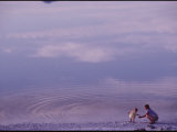 A Mother and Child Playing by a Lake Photographic Print by Kenneth Garrett