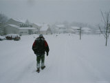 A Teenager Trudging Through Heavy Snow Photographic Print