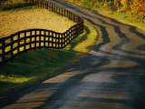 Twilight View of a Wooden Fence and its Shadow Along a Country Road Photographic Print by Kenneth Garrett