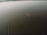 A Boy in a Life-Vest Floats Peacefully on the Calm Surface of the Wye River Photographic Print by Stephen St. John