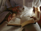 Reading an Old Bible During a Service Photographic Print