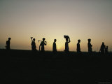 Laborers Silhouetted against the Setting Sun Photographie par Dick Durrance II