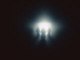 The Silhouette of Three Figures Dressed in Robes Standing Before a Bright Light Photographic Print by Todd Gipstein