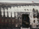 The Burnt out Hull of a Jet Sits on a Tarmac Photographie