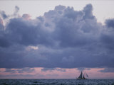 Distant Sailboat under Dramatic Clouds Photographie