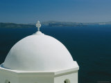A Crucifix Atop the Domed Roof of a Church Overlooking the Aegean Photographic Print