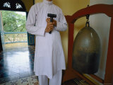 A Man Standing with a Mallet to Ring a Metal Bell Photographie