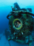 Scientist Greg Stone Peers out of One of the Windows on Aquarius Photographic Print by Brian J. Skerry
