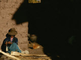 A Peruvian Woman Spins Wool into Thread on a Spool Photographic Print by Kenneth Garrett