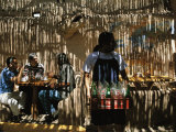 Filtered sunlight casts shadows on cafe patrons and staff 写真プリント