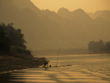 Woman Fishes Along the Mingjiang River at Sunset Photographic Print by Raymond Gehman