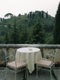 Cafe Table and Chairs Overlooking a Villa on a Hill Photographic Print