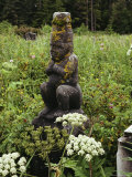 A Lichen-Covered Haida Indian Watchman Atop a Gravestone Photographic Print