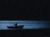 A Woman Rows a Boat Across a Yoho National Park Lake at Dusk Photographic Print by Michael Melford