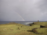 A Rainbow Arches Above Statues Carved from Volcanic Rock Photographic Print
