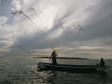 A Ugandan Man Casts a Fishing Net for Tilapia Photographic Print