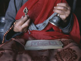 Buddhist Lama with Prayer Book, Prayer Beads and Dorge Photographic Print by Gordon Wiltsie