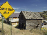 A Yellow Street Sign Reading Congested Area Next to a Run-Down Barn Fotografisk trykk av Todd Gipstein