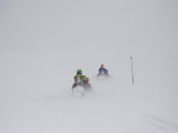 Two Snowmobilers Disappear into the Blizzard on a Winter Day Lámina fotográfica