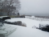 Looking Out from a Porch to the River During a Snow Storm Photographic Print