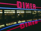 A Neon Diner Sign Relects off a Car Roof Photographic Print
