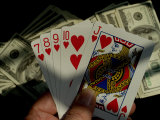 Hand Holding a Straight Flush in Front of Several Hundred Dollar Bills Photographic Print