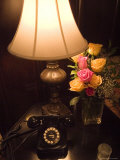Replica of Old Telephone on a Table with a Lamp and a Vase of Roses Photographie par Todd Gipstein
