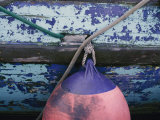 A Colorful Buoy Hangs from Ropes off the Side of a Boat Photographie par George F. Mobley