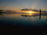 Sunset Sky Silhouettes a Young Boy Walking Along the Edge of a Pool Photographic Print by Jodi Cobb