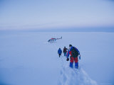 Scientists Studying the Volcano Trudge Through the Snow Toward a Waiting Helicopter Photographic Print by Steve Winter