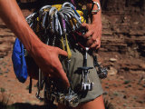 A Rock Climber Check Her Gear Before a Climb Photographic Print by Bill Hatcher