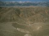 An Aerial View of a Mountain Valley Bisected by a Road Photographie