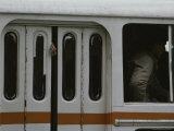 A Mans Hand Hangs out of a Closed Door on a Crowded Bus Photographic Print