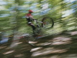 A Boy Flies Through the Air on His Mountain Bike Photographic Print by Roy Gumpel
