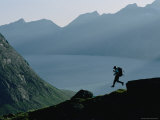A Man Runs Down a Hill Toward Base Camp Near Tasermiut Fjord Photographie